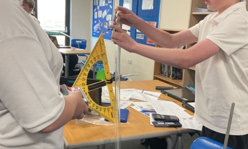 Two older students working on a science experiment