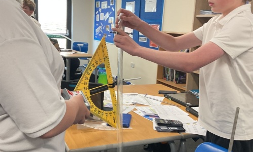Two older students working on a science experiment