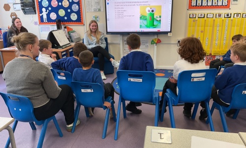Student studying Childcare presenting on the whiteboard to a group of our Foundation students