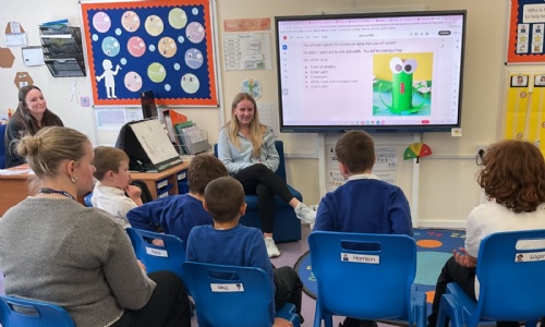 Student studying Childcare presenting on the whiteboard to a group of our Foundation students
