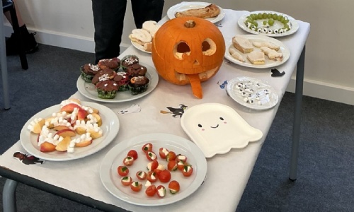 Earth Classes Halloween party food display which includes cup cakes, marshamallow teeth and filled grape eye balls.